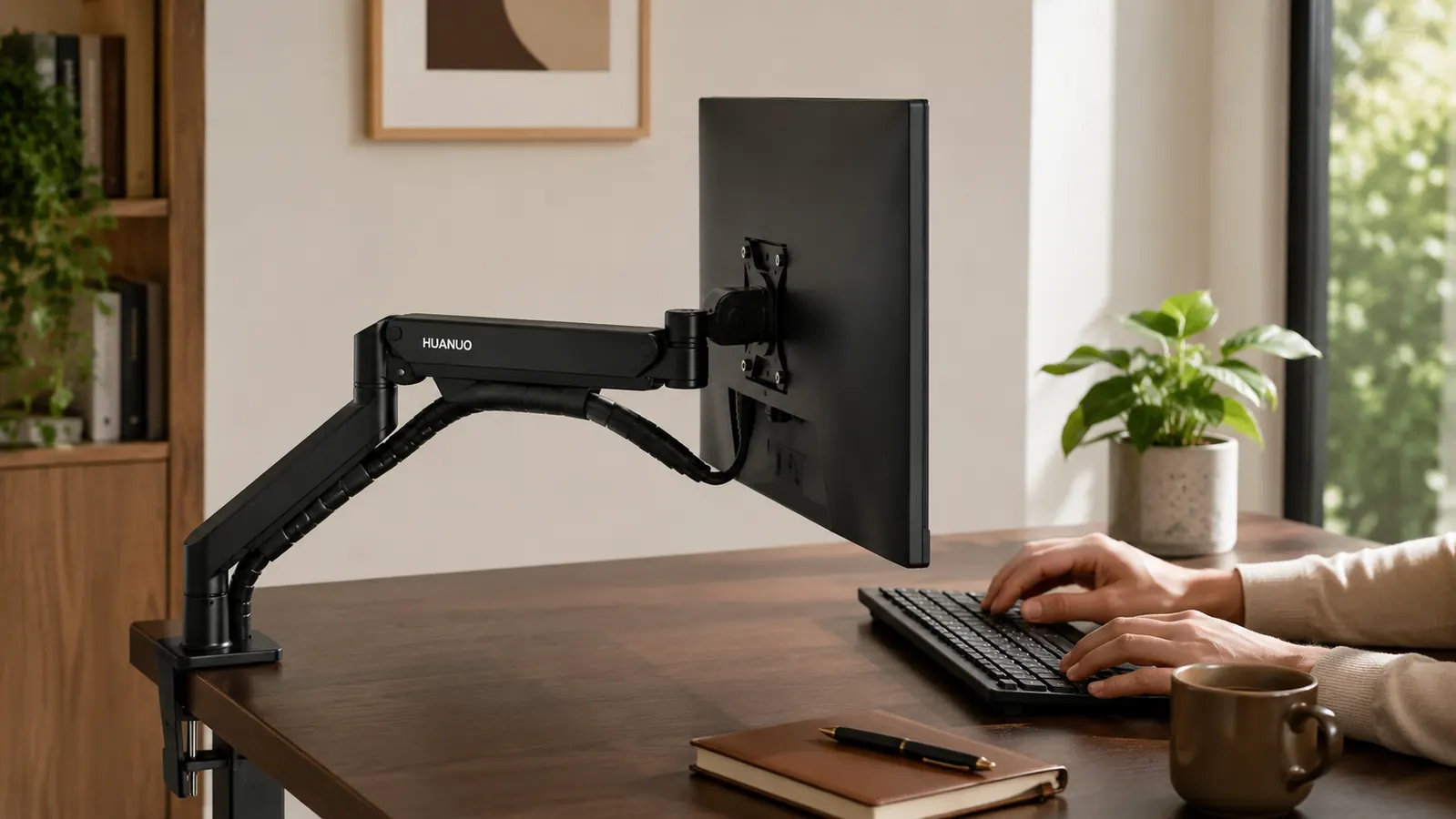 Side view of the HUANUO monitor arm clamped to a desk edge, arm extended and screen tilted at eye level